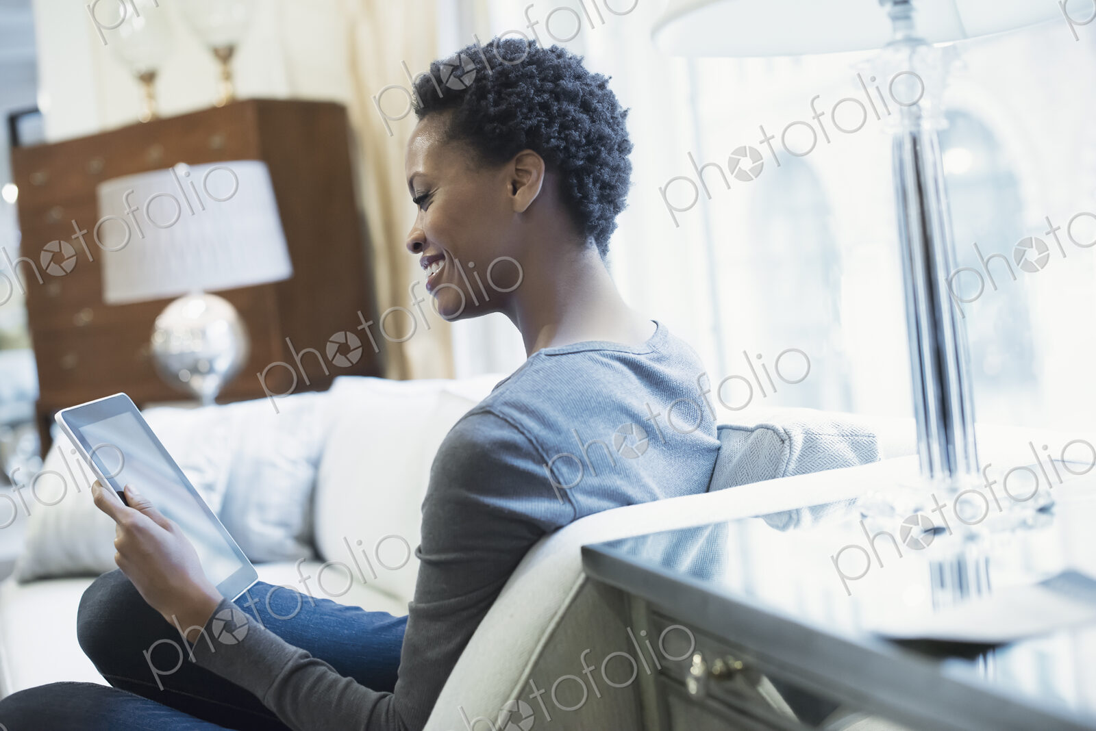 Woman relaxing at home with tablet