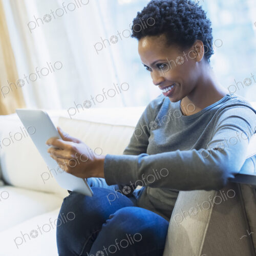 Woman relaxing at home with tablet Woman relaxing at home with tablet