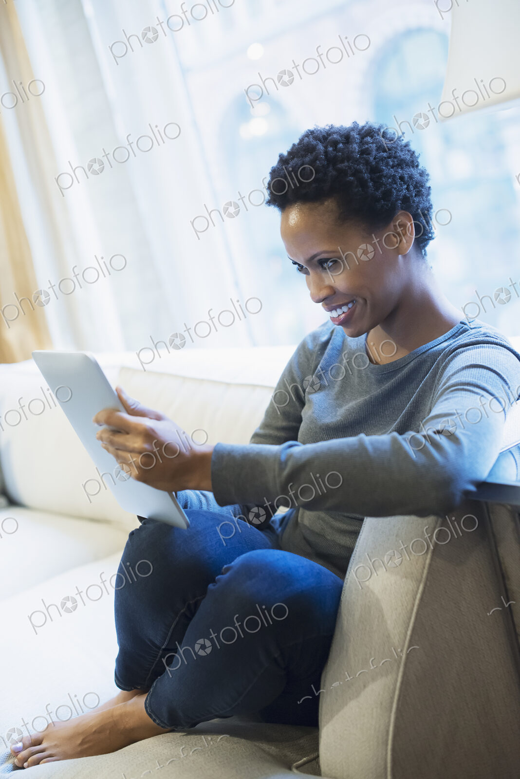 Woman relaxing at home with tablet