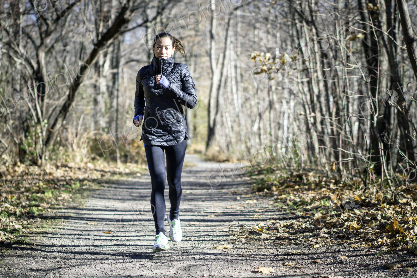 Woman running on dirt path in autumn