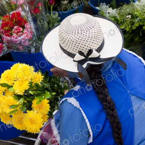 Woman selling flowers in South American street.