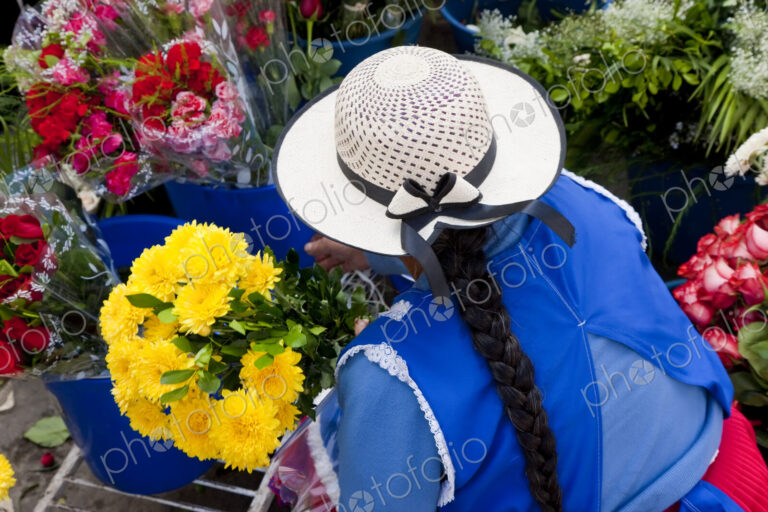 Woman selling flowers in South American street.