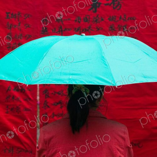 Woman under umbrella, China