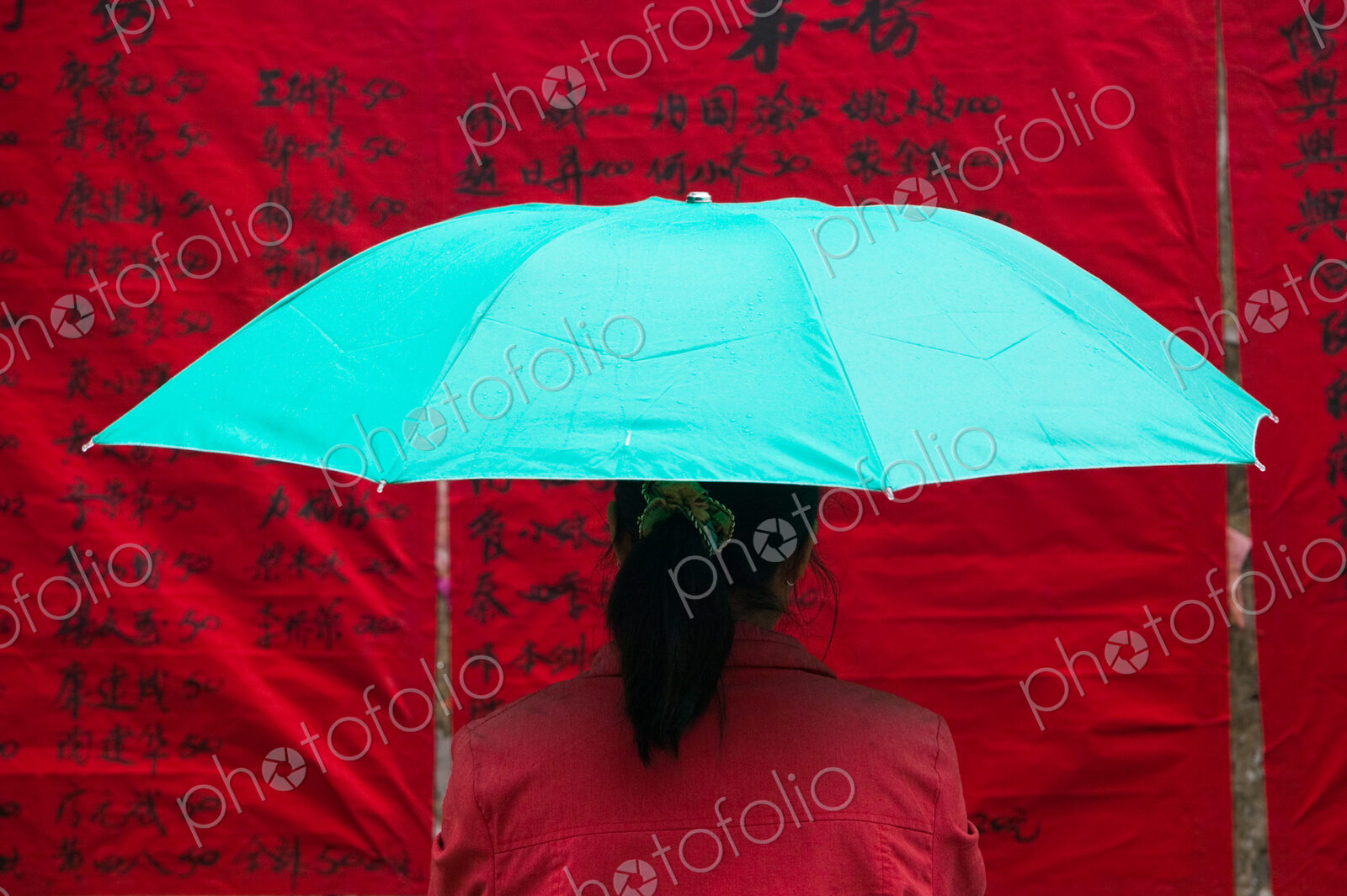 Woman under umbrella, China