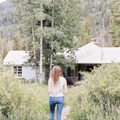 Woman walking along a footpath on a ranch.