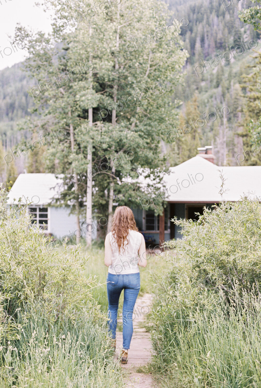 Woman walking along a footpath on a ranch.