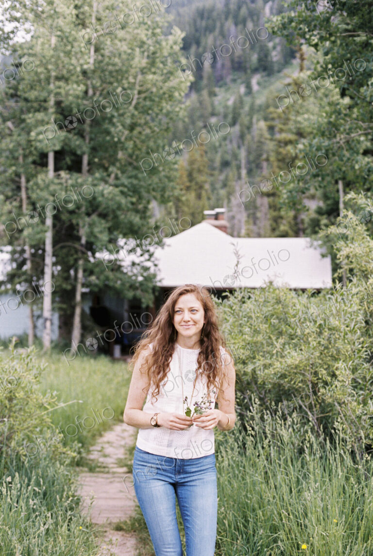 Woman walking along a footpath on a ranch.