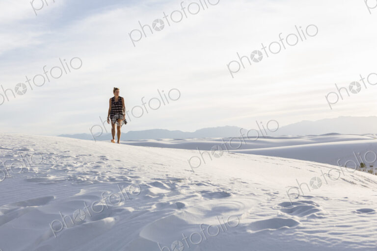 Woman walking in the dunes, White Sands Nat'l Monument, NM