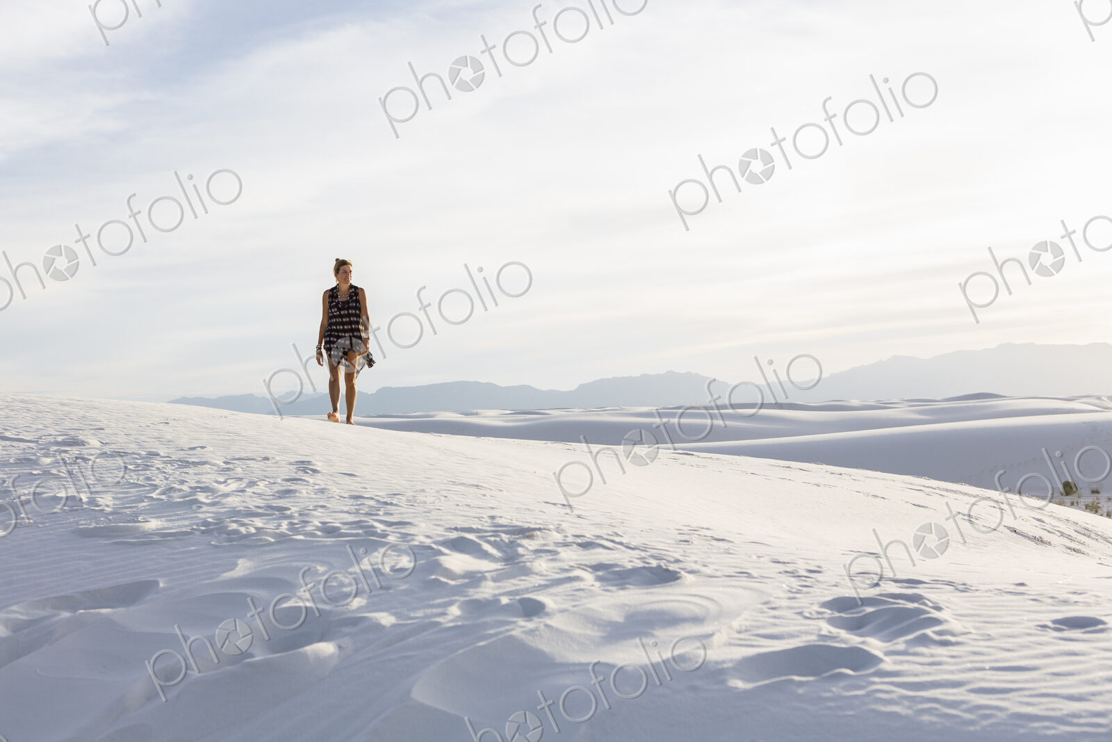 Woman walking in the dunes, White Sands Nat’l Monument, NM