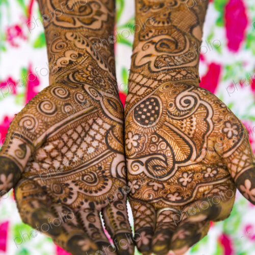 Woman's hands covered in Henna tattoos Woman's hands covered in Henna tattoos