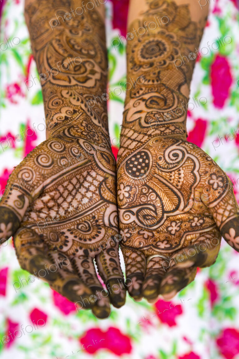 Woman's hands covered in Henna tattoos