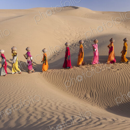 Women bear the responsibility of fetching water from the sparse wells within…