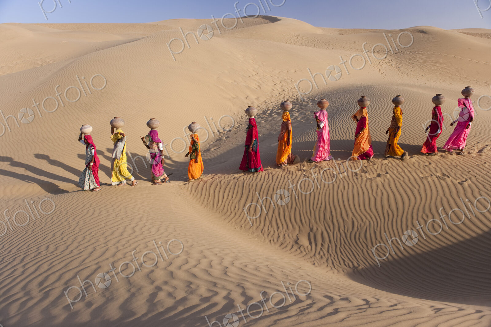 Women bear the responsibility of fetching water from the sparse wells within…