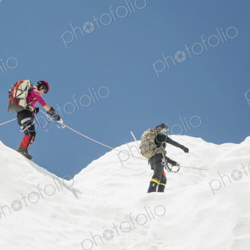 Women hiking on snowy mountain, Everest, Khumbu region, Nepal Women hiking on snowy mountain, Everest, Khumbu region, Nepal