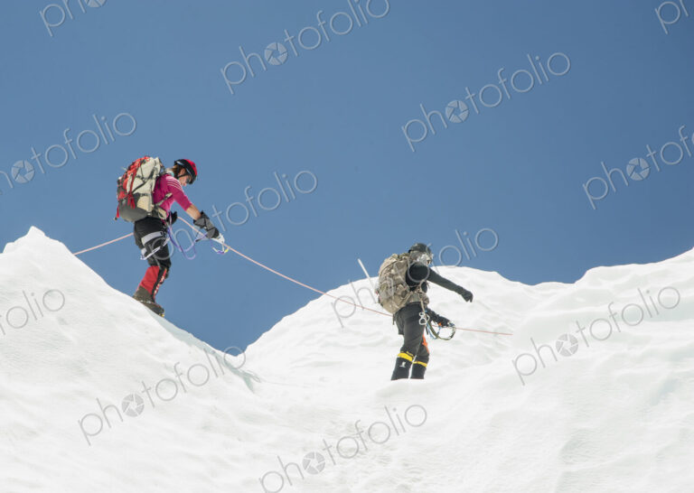 Women hiking on snowy mountain, Everest, Khumbu region, Nepal