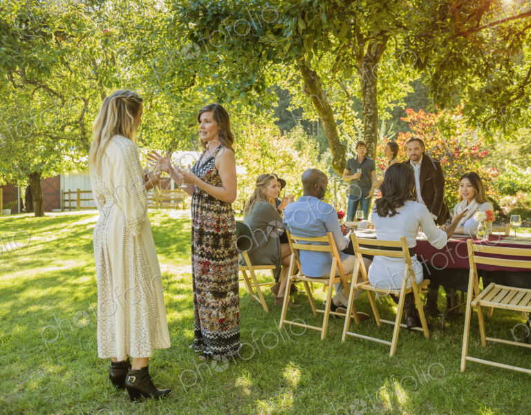 Women standing and talking at party outdoors