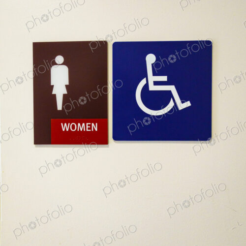Women's room with ADA disabled person's access sign.