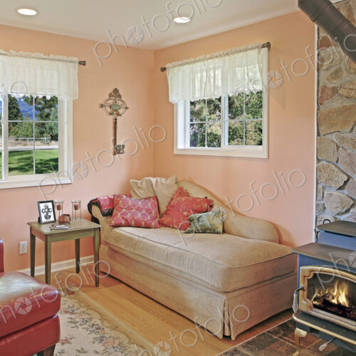 Wood stove and daybed in rustic living room