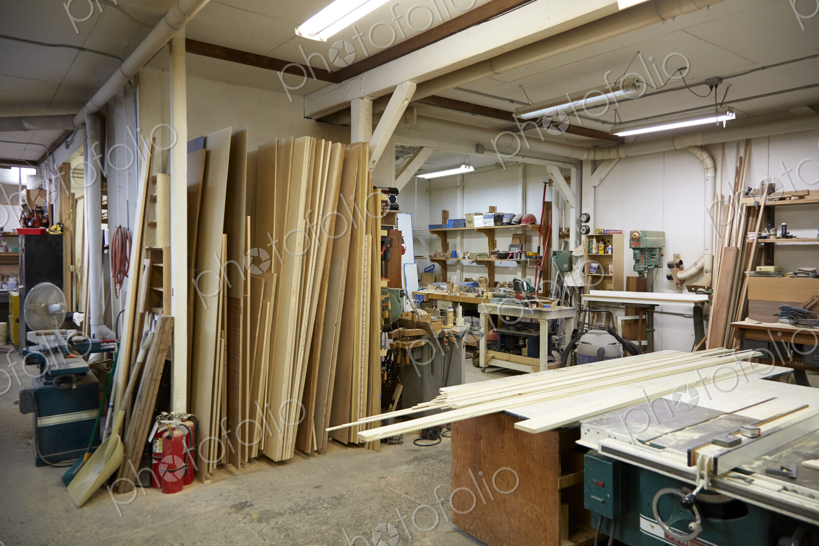 Wood, work benches and tools in workshop