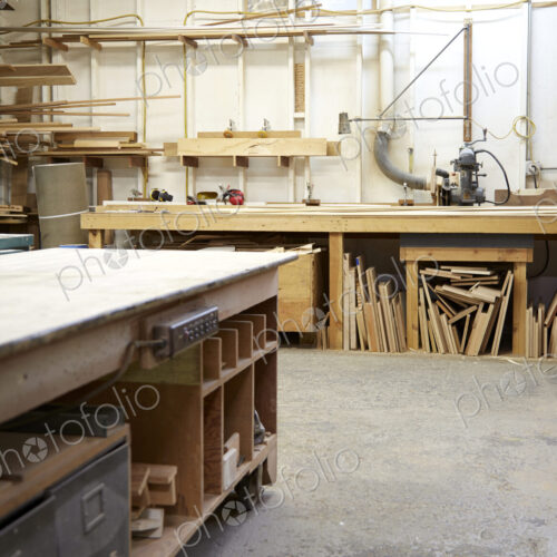Wood, workbenches and tools in workshop