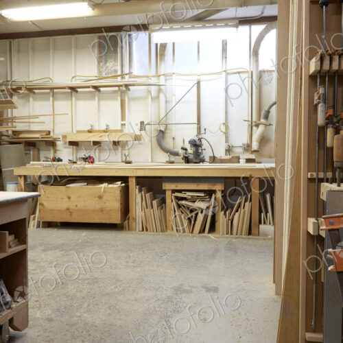 Wood, workbenches and tools in workshop