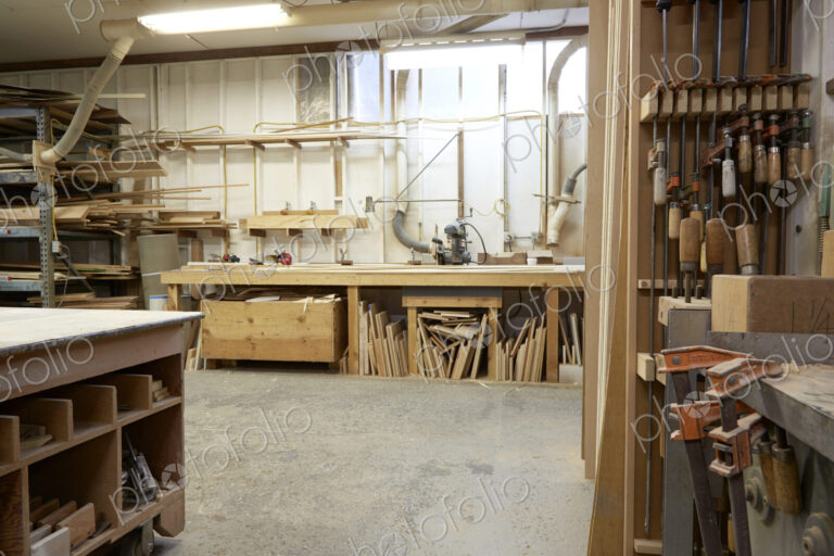 Wood, workbenches and tools in workshop