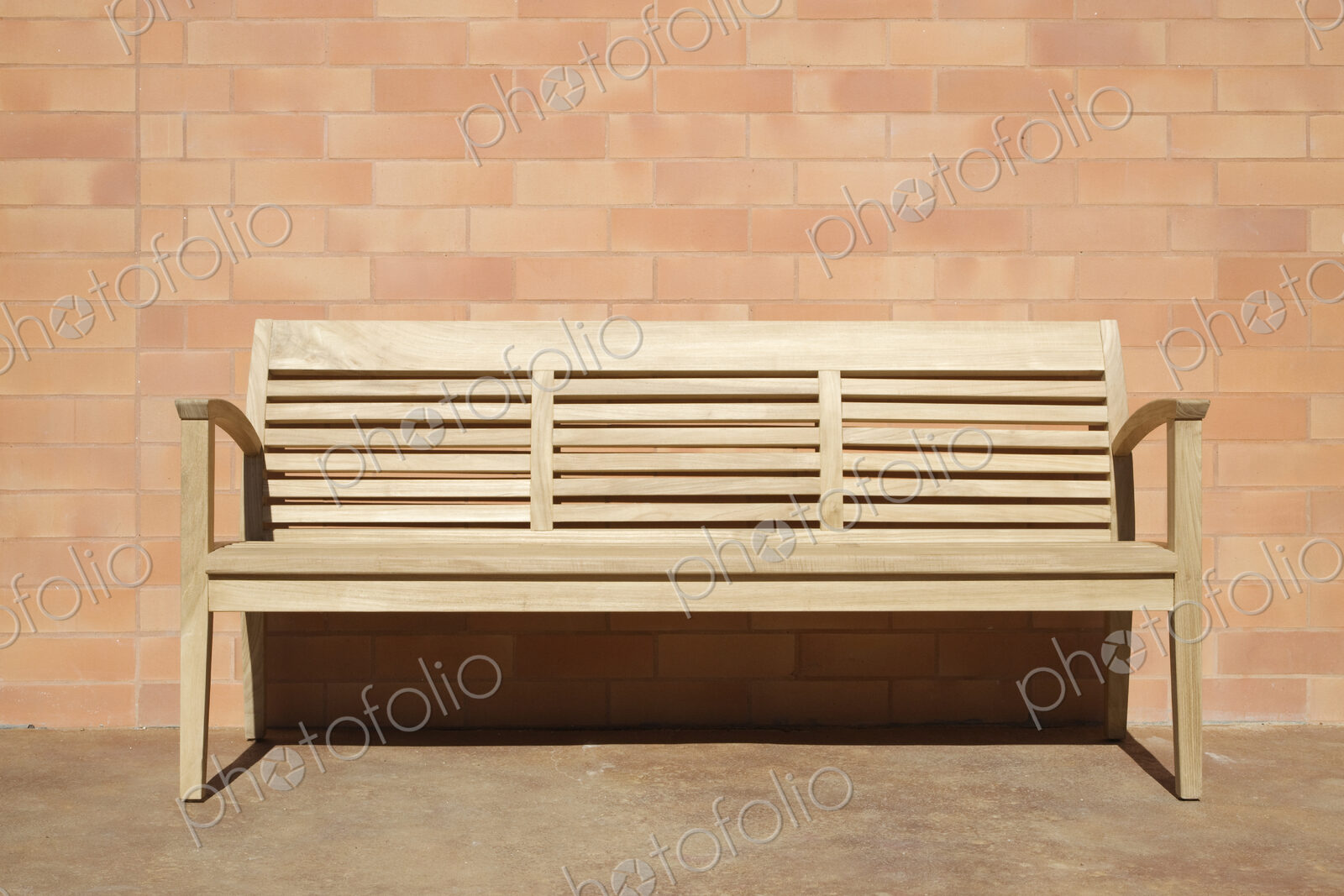 Wooden Bench Set Against Brick Wall