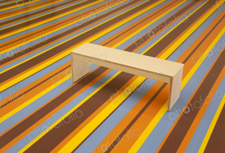 Wooden Bench on a vibrant Striped Floor