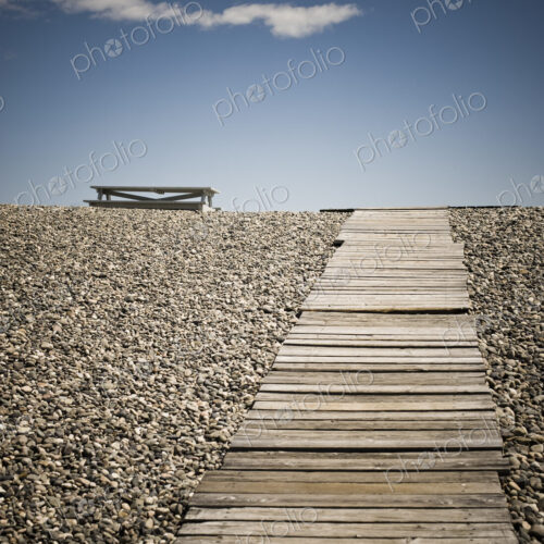 Wooden Walkway and Picnic Table at the Beach