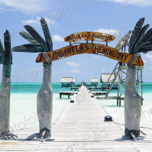 Wooden arch entrance to a pier in tropical ocean. Wooden arch entrance to a pier in tropical ocean.