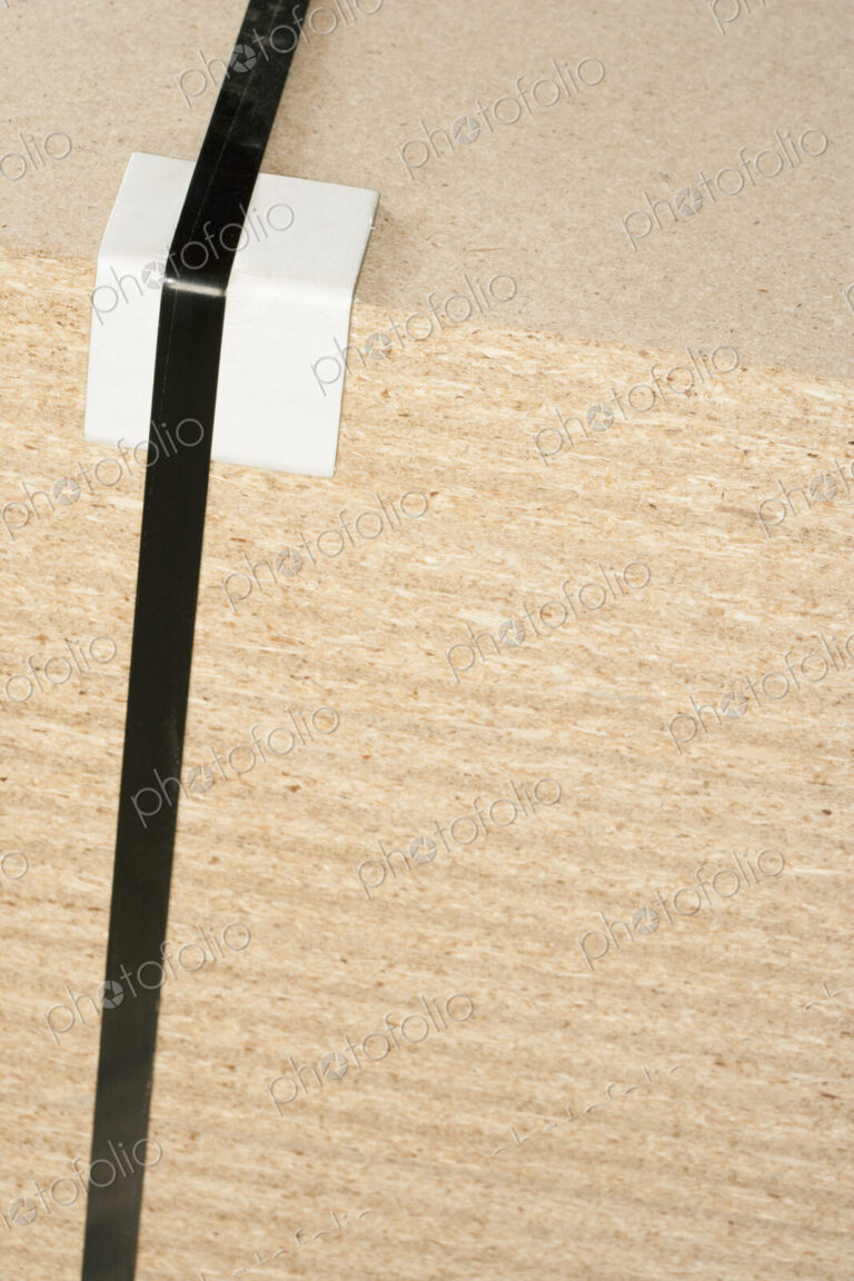 Wooden block with tape and bumper block to protect corner.