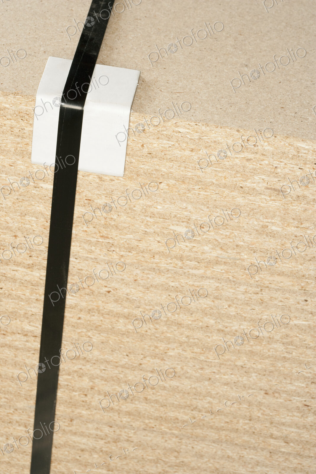 Wooden block with tape and bumper block to protect corner.