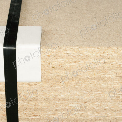 Wooden block with tape and bumper block to protect corner. Wooden block with tape and bumper block to protect corner.