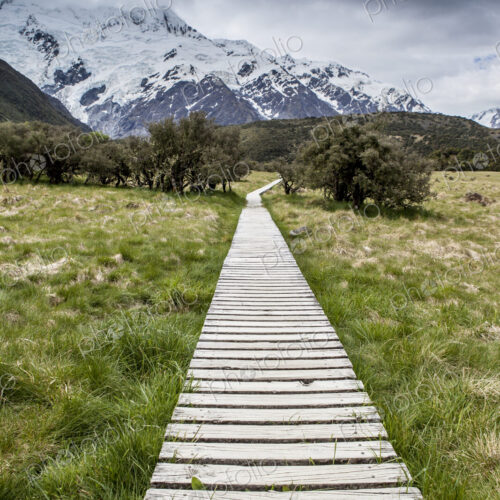 Wooden boardwalk toward mountain range