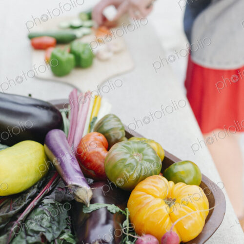 Wooden bowl with fresh vegetables standing on a table. Wooden bowl with fresh vegetables standing on a table.