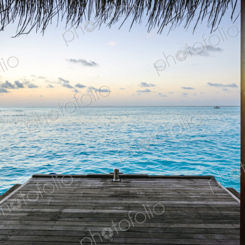 Wooden dock and ocean at sunset Wooden dock and ocean at sunset