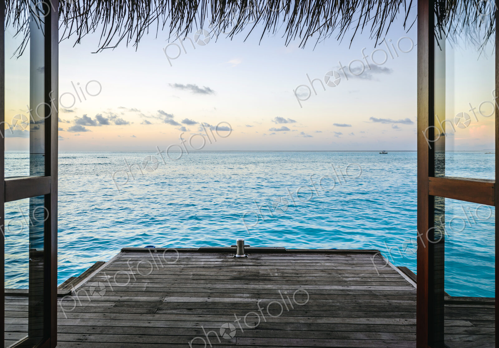 Wooden dock and ocean at sunset