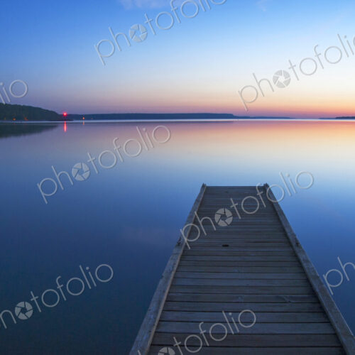 Wooden dock over still lake Wooden dock over still lake