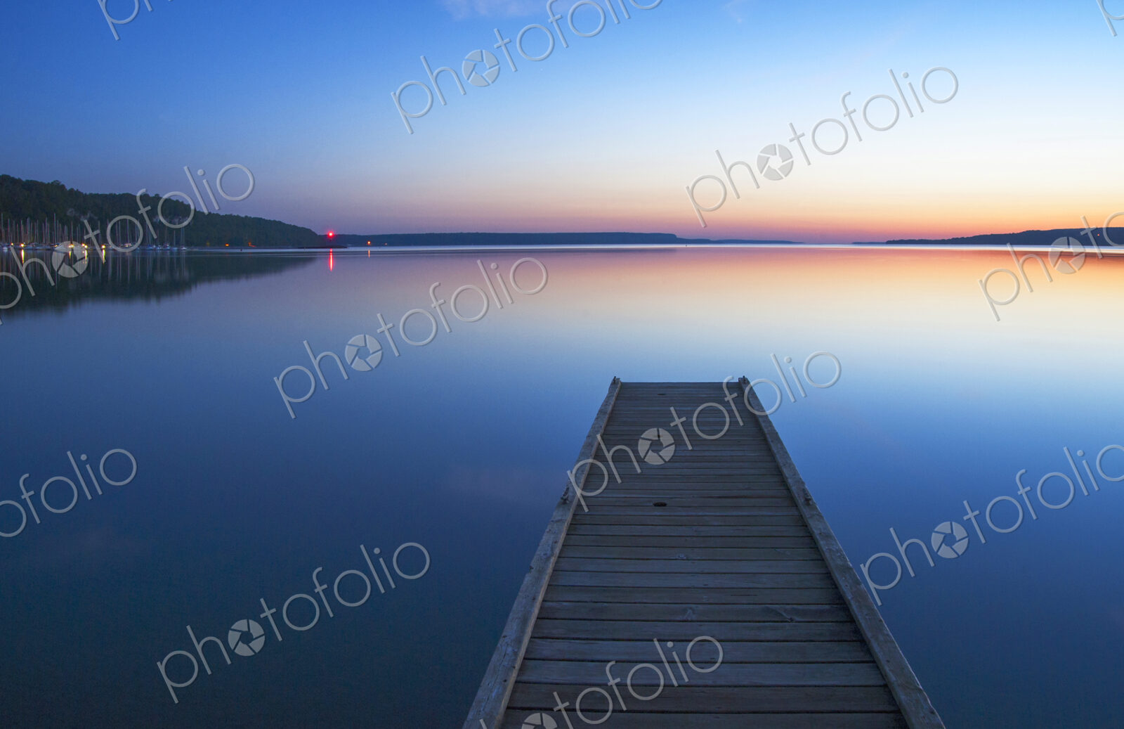 Wooden dock over still lake