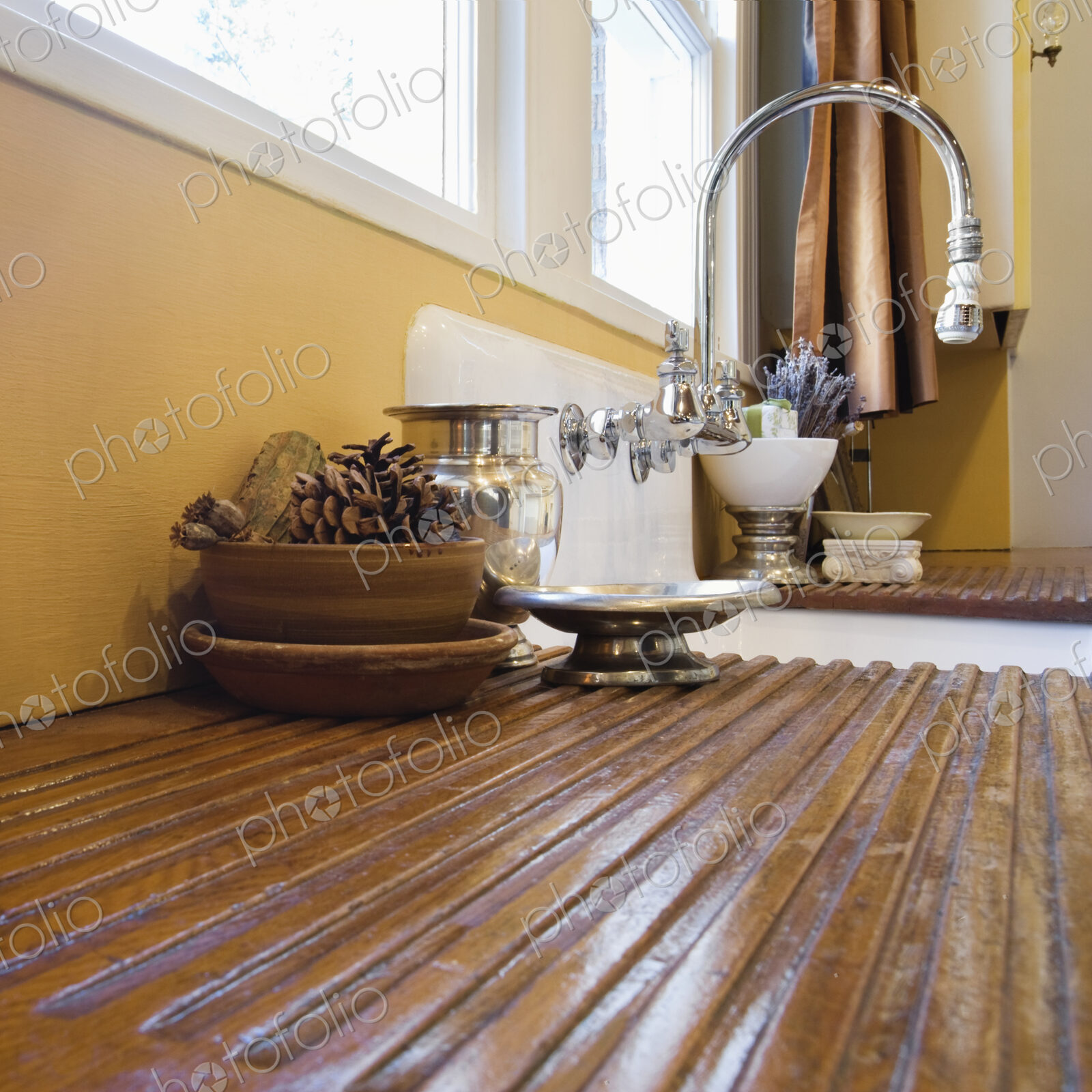 Wooden draining board and kitchen sink.