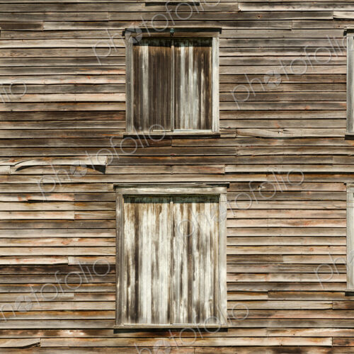 Wooden house exterior with American flag in window Wooden house exterior with American flag in window