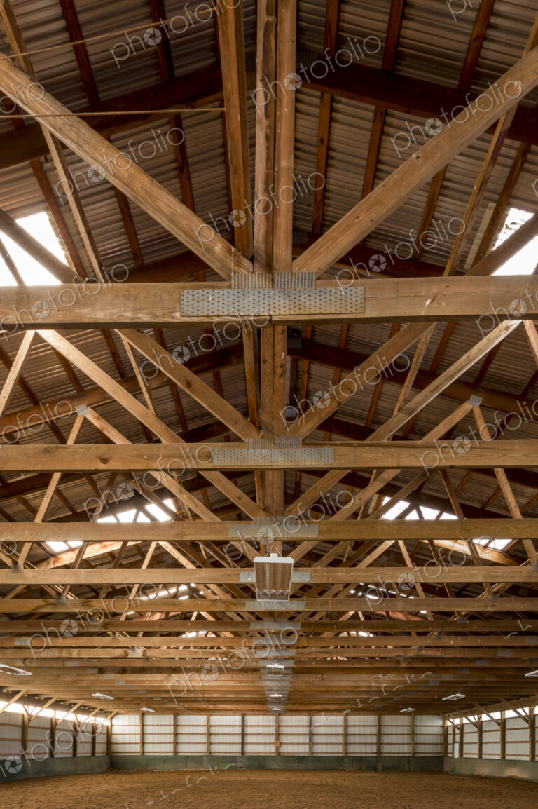 Wooden rafters in indoor horse riding ring