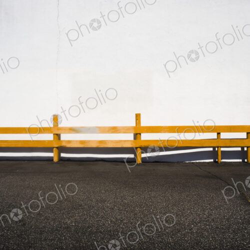 Wooden railing over asphalt. Wooden railing over asphalt.