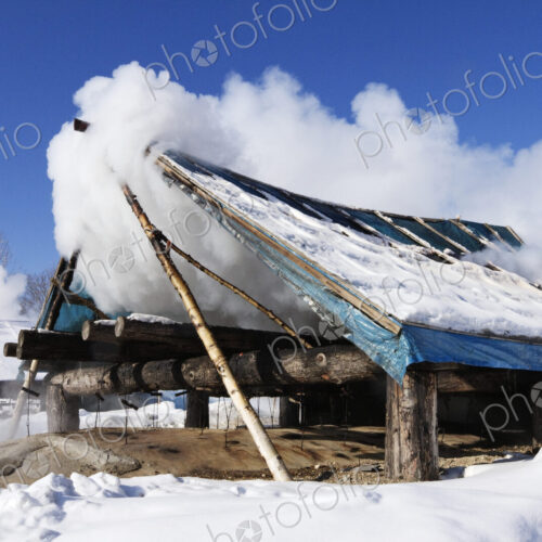 Wooden shack covered with clouds in snow. Wooden shack covered with clouds in snow.