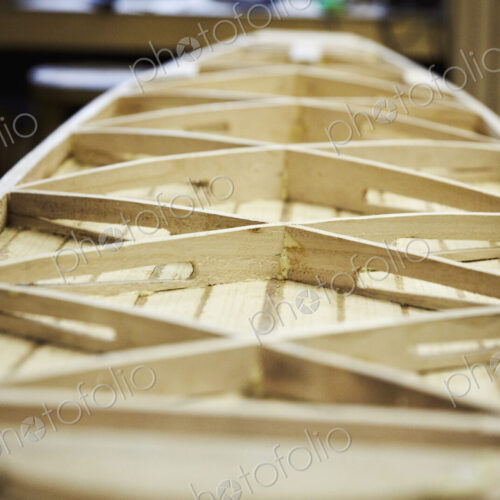 Wooden surfboard under construction, view of the interior struts. Wooden surfboard under construction, view of the interior struts.