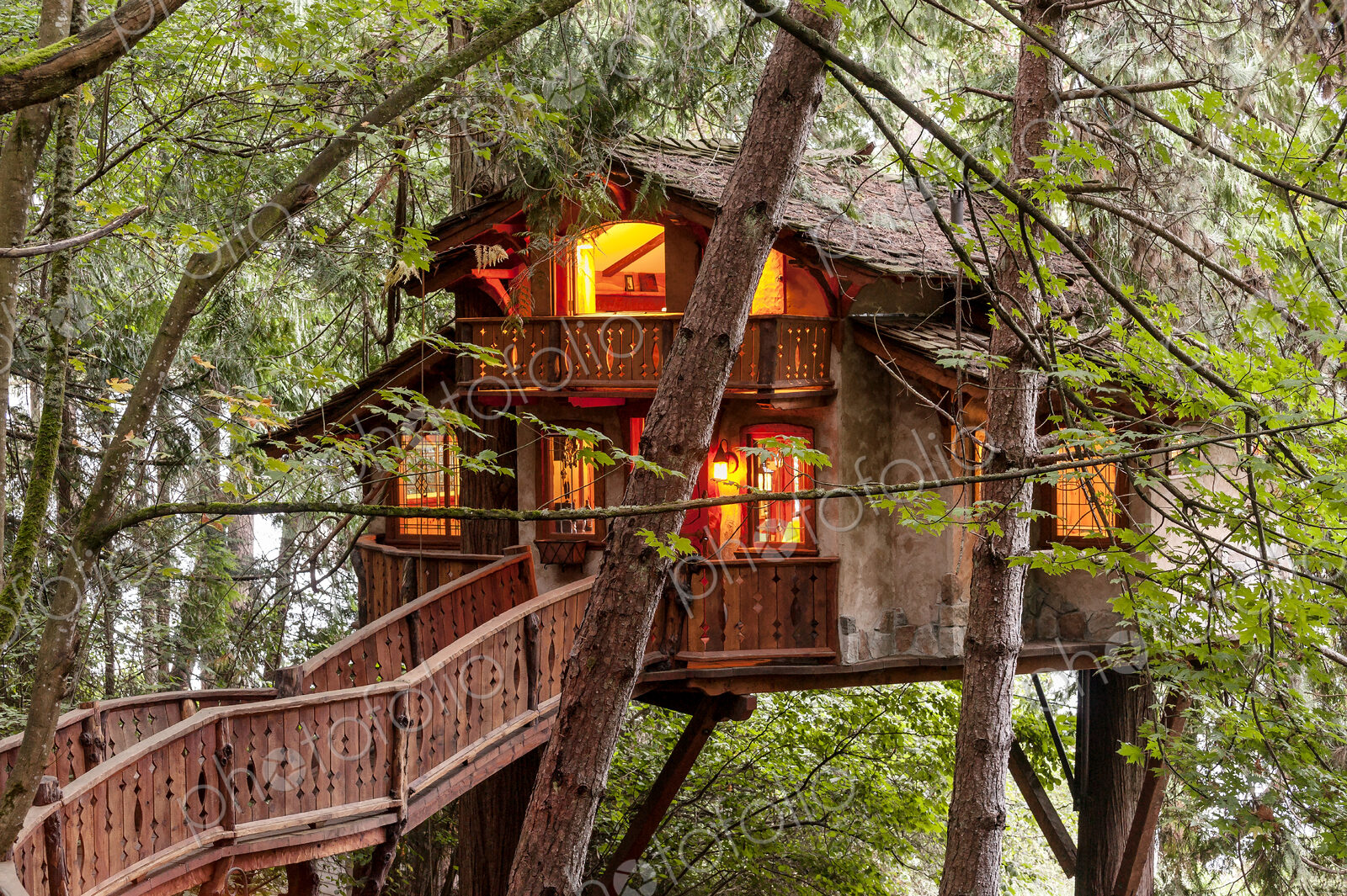 Wooden walkway to illuminated tree house