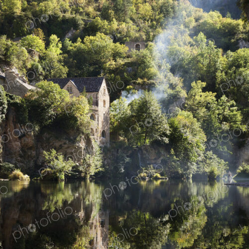 Woodland, and a thin stream of rising woodsmoke, elevated view of river Woodland, and a thin stream of rising woodsmoke, elevated view of river