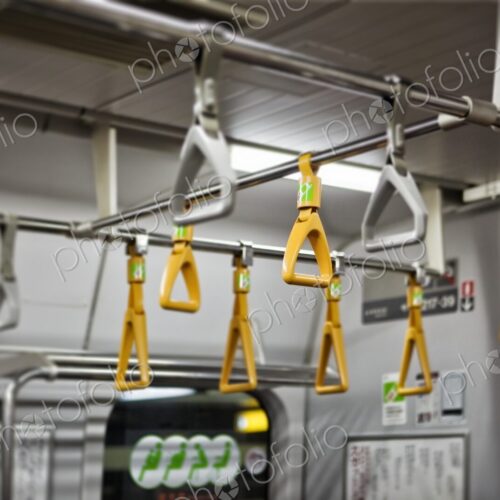 Yellow and grey handholds on an empty subway train, Tokyo, Japan