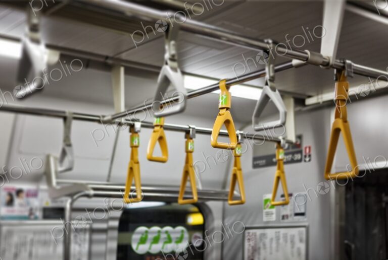 Yellow and grey handholds on an empty subway train, Tokyo, Japan