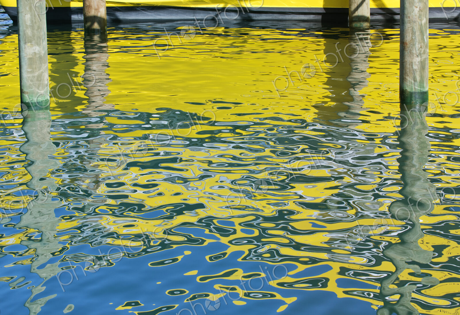 Yellow boat reflected in water